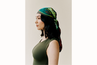 Side profile of the model wearing scarf styled as a headscarf.