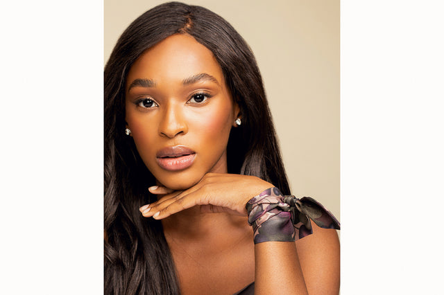 Image of female model wearing the wrapped around her wrist and secured with a simple knot to create a silk bracelet. The model is also wearing a chocolate brown silk tank top.