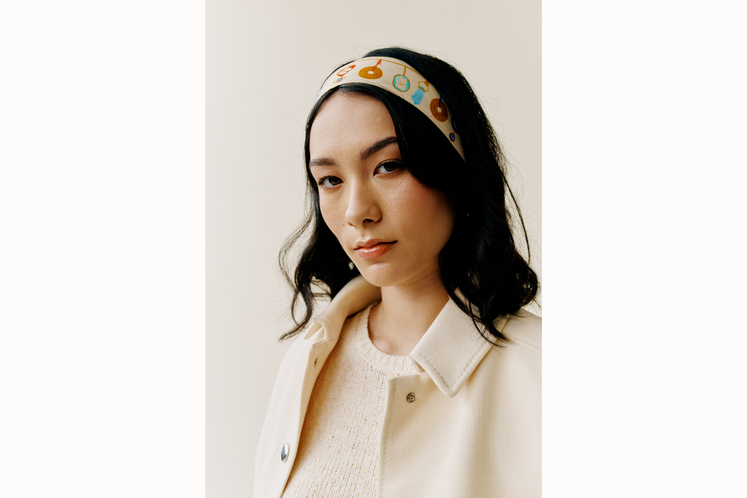 Model wears scarf styled as a headband