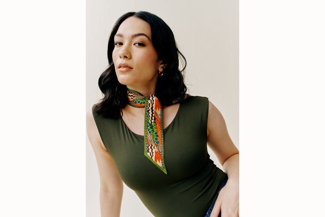 image of female model wearing a green tank and a silk twiggy scarf styled as a tie