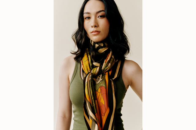 female model wears green tank and scarf tied in the front in a cowgirl styled knot