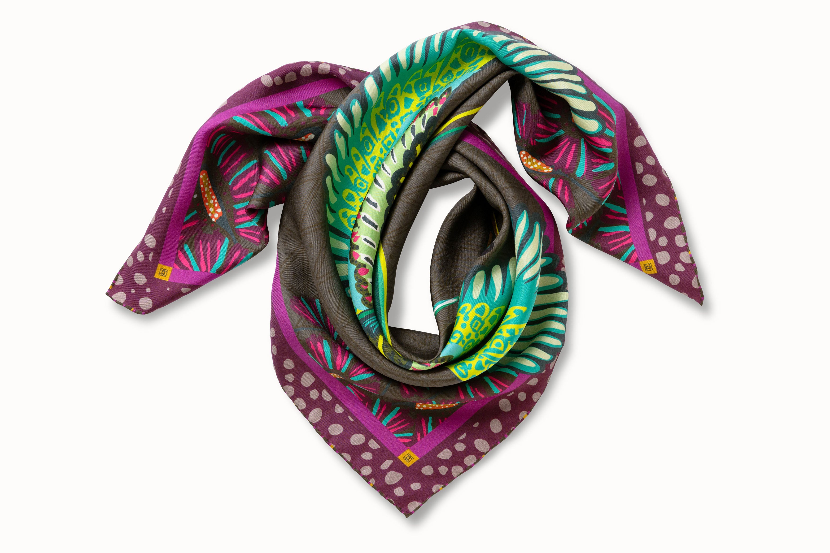 Rolled image of 100% silk square scarf featuring a motif of two large-scale cranes with brightly colored wings in shades of blue and green with geometric designs. The scarf’s center background is a tonal army green and the border features irregular grey polka dots on a magenta background.