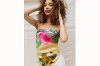 woman with curly hair wearing flower print scarf